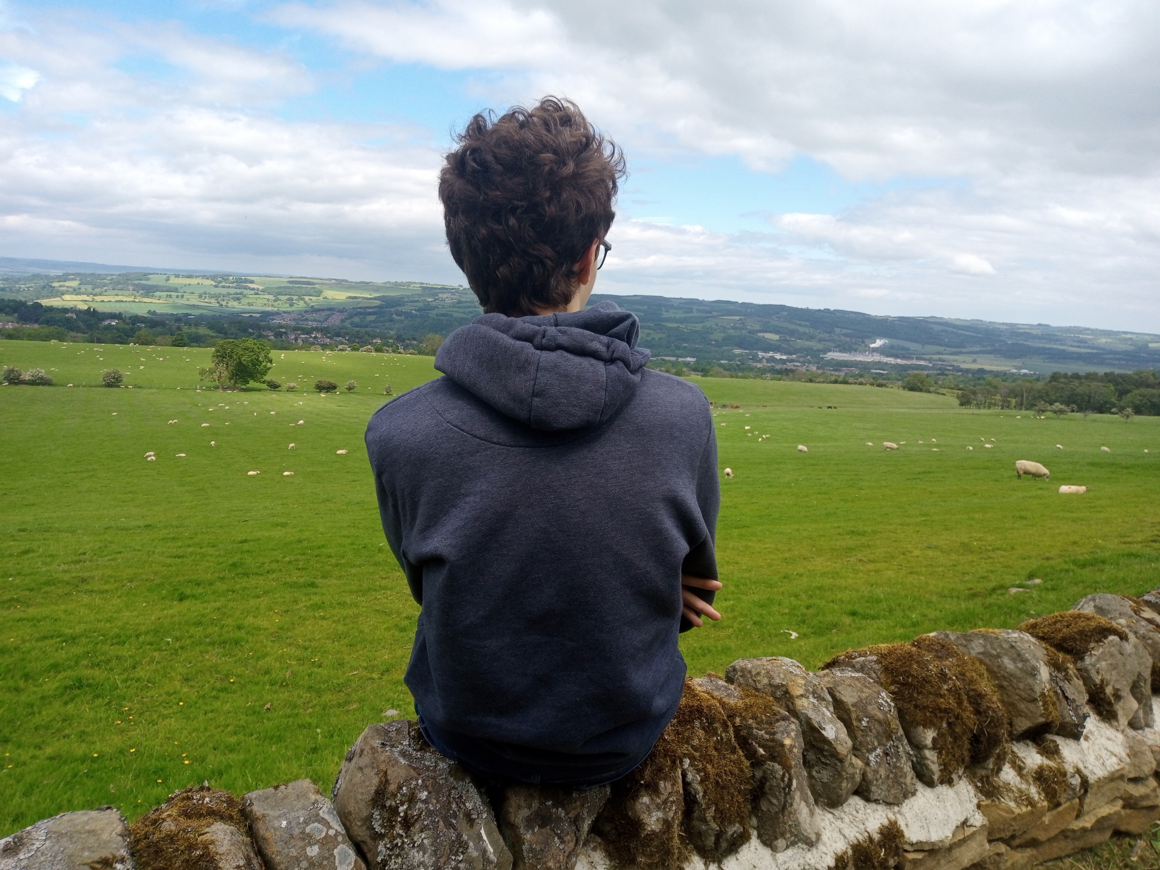 Oliver sat facing towards a town in the distance.
